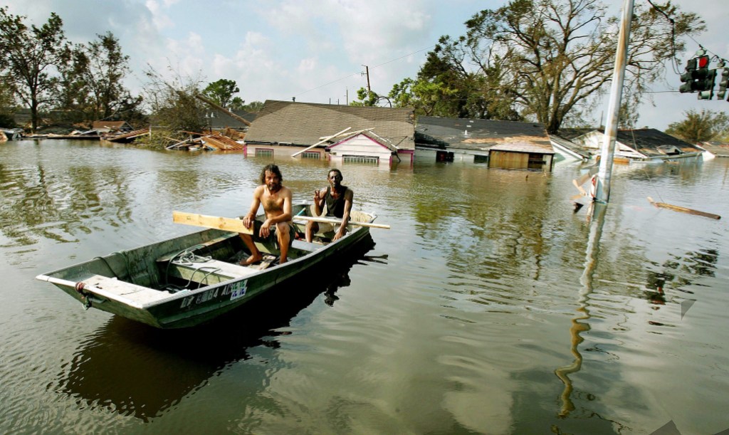 NEW ORLEANS - AUGUST 31: Two men paddle in high water in the Ninth Ward after Hurricane Katrina devastated the area August 31, 2005 in New Orleans, Louisiana. Devastation is widespread throughout the city with water approximately 12 feet high in some areas. Hundreds are feared dead and thousands were left homeless in Louisiana, Mississippi, Alabama and Florida by the storm. (Photo by Mario Tama/Getty Images)