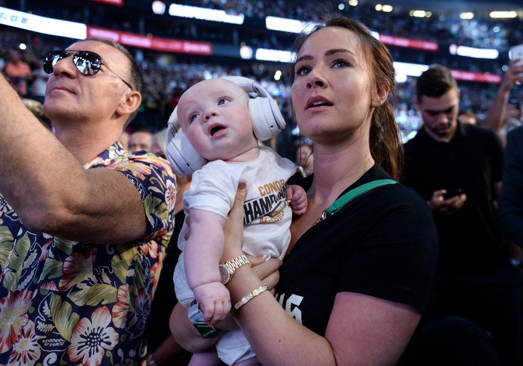 LAS VEGAS, NV - AUGUST 25:  Dee Devlin holds Conor McGregor Jr. and watches as Conor McGregor pose on the scale during his official weigh-in at T-Mobile Arena on August 25, 2017 in Las Vegas, Nevada. McGregor will meet boxer Floyd Mayweather Jr. in a super welterweight boxing match at T-Mobile Arena on August 26. (Photo by Brandon Magnus/Zuffa LLC/Zuffa LLC via Getty Images)