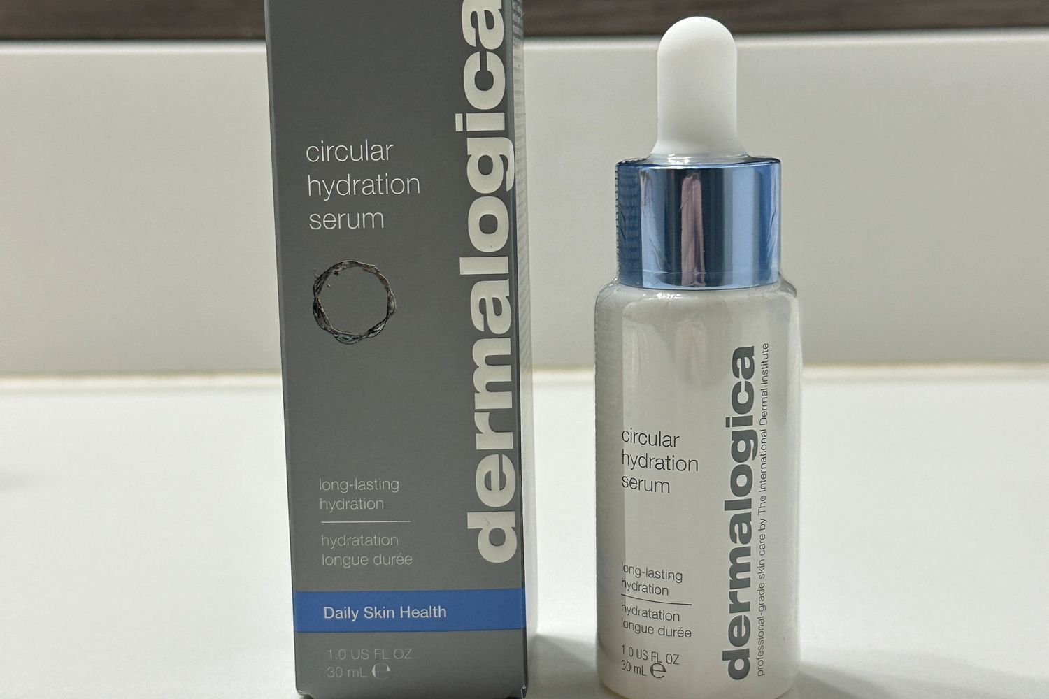 The Dermalogica Circular Hydration Serum with Hyaluronic Acid bottle and box on a marble surface 