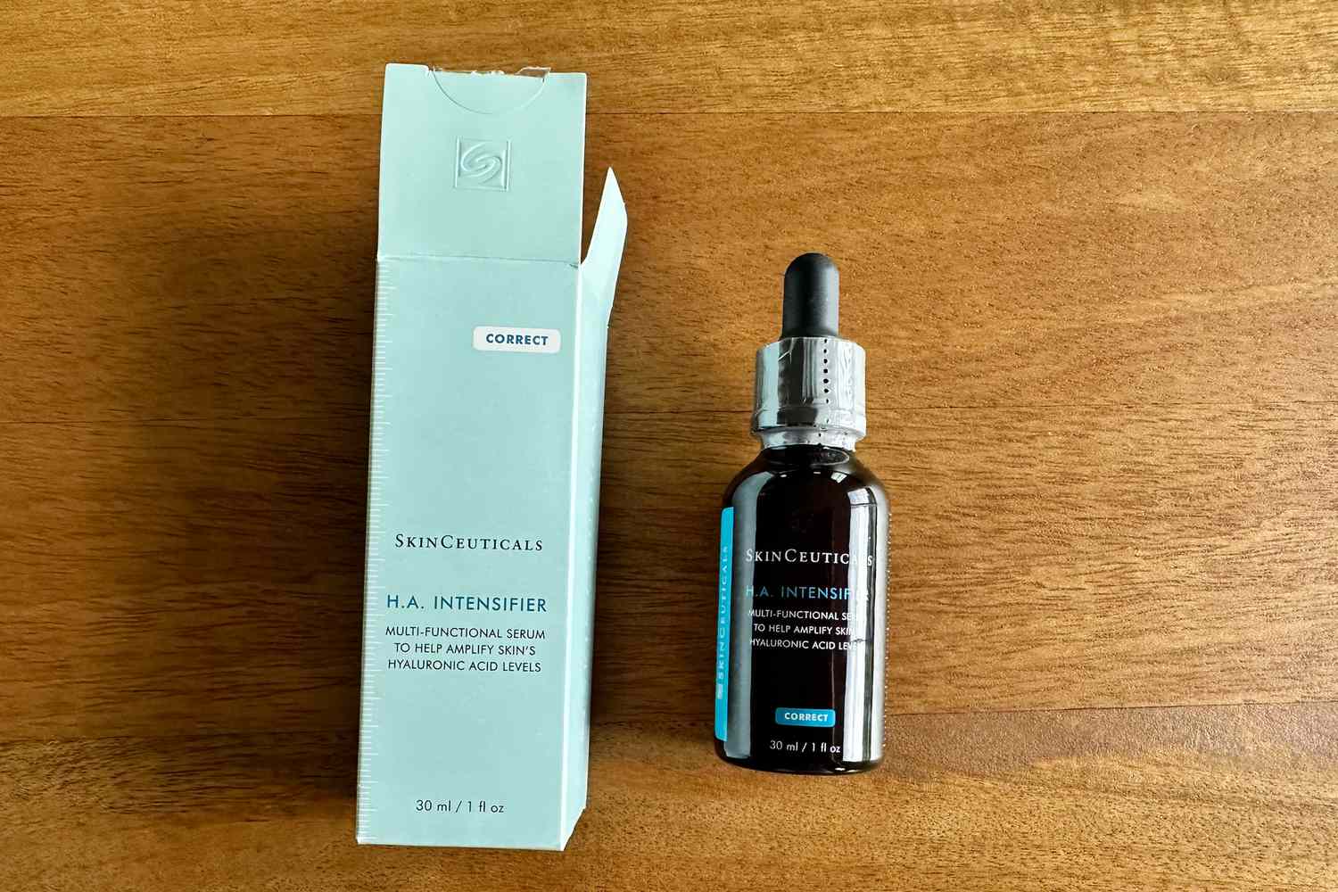 SkinCeuticals Hyaluronic Acid Intensifier Serum and box displayed on a wood surface