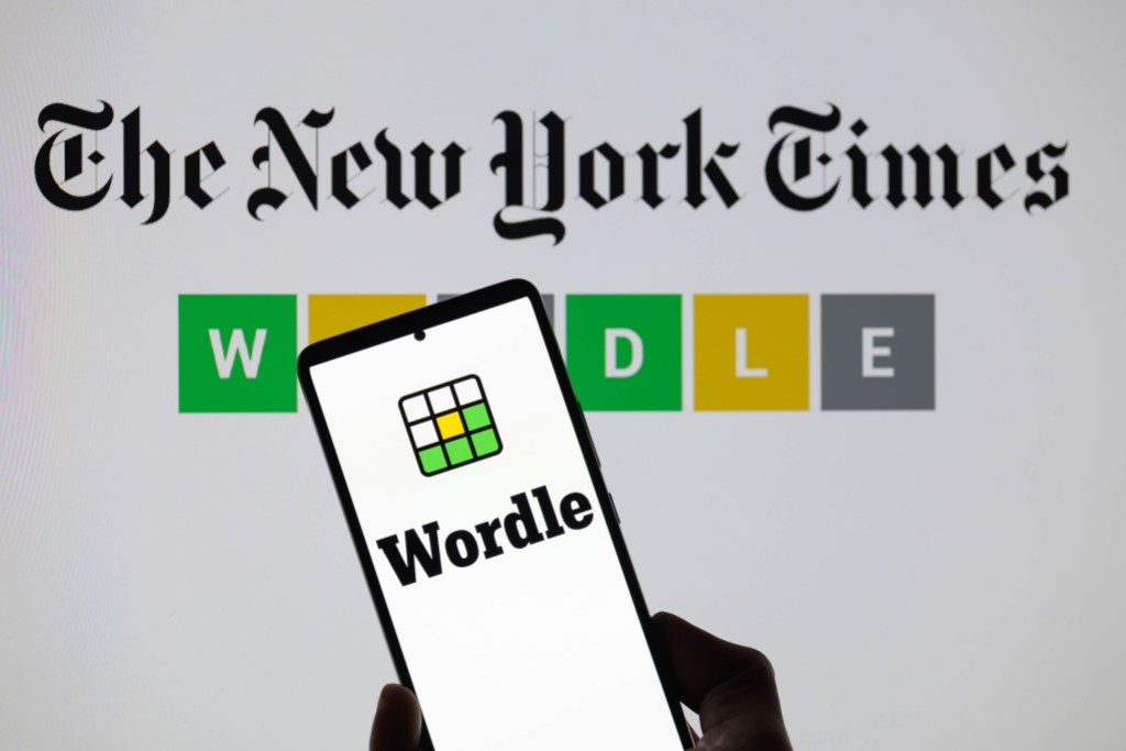 The Wordle logo is being displayed on a smartphone with The New York Times visible in the background in this photo illustration in Brussels, Belgium, on June 1, 2024. (Photo by Jonathan Raa/NurPhoto)