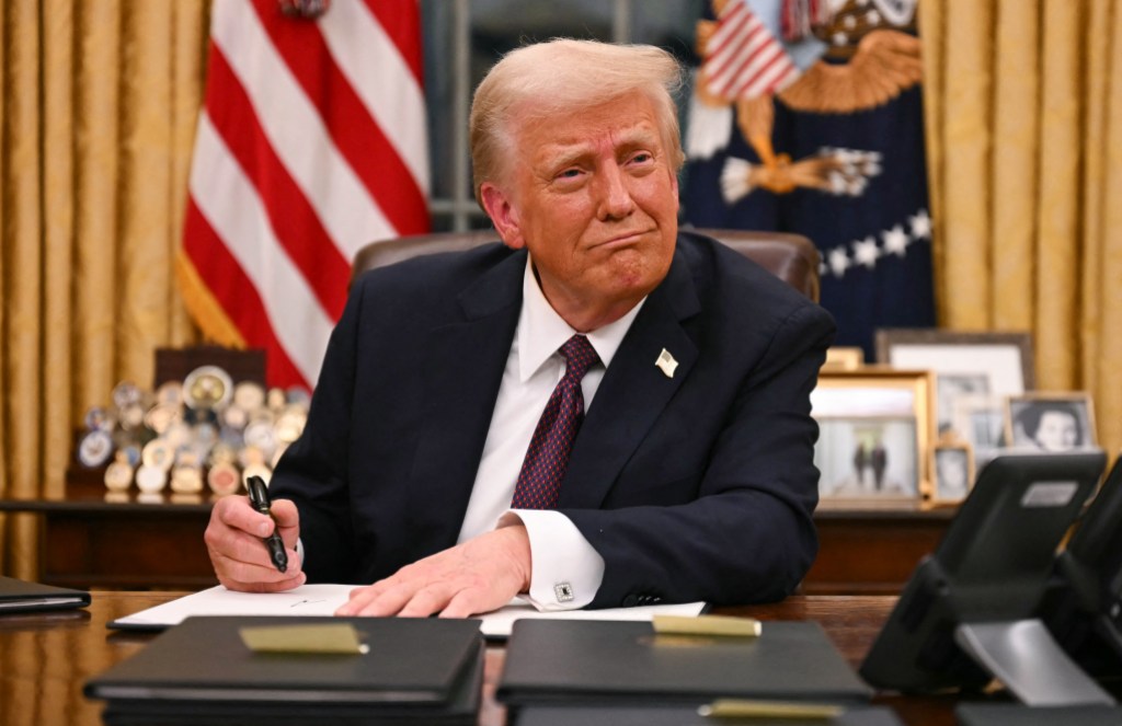 US President Donald Trump signs executive orders in the Oval Office of the White House in Washington, DC, on January 20, 2025. (Photo by Jim WATSON / AFP)