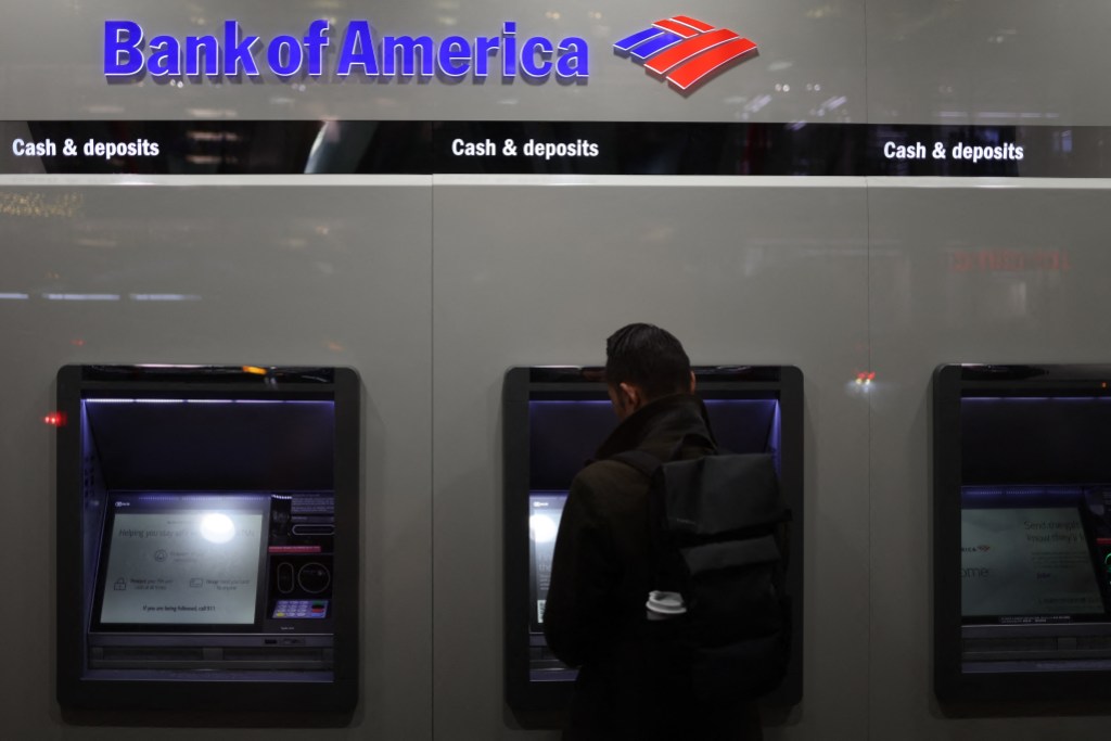 A person uses an ATM at a Bank of America in New York City on November 19, 2024. (Photo by CHARLY TRIBALLEAU / AFP)