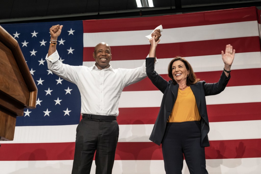 NEW YORK, USA - NOVEMBER 05:  Mayor Eric Adams and Kathy Hochul on stage during election campaign rally for Governor Kathy Hochul organized by New York State Democratic Committee at BKLYN Studios in New York on November 5, 2022. Rally featured Attorney General Letitia James, State Comptroller Tom DiNapoli, Senate Majority Leader Chuck Schumer, Representative Hakeem Jeffries, New York City Mayor Eric Adams and actress Rosie Perez. (Photo by Lev Radin/Anadolu Agency via Getty Images)