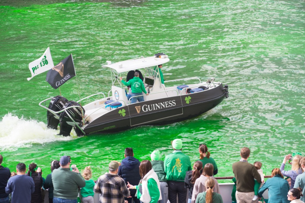 CHICAGO, ILLINOIS, UNITED STATES - MARCH 15: A boat pours environmentally friendly dye into the Chicago River, creating a stunning visual effect during St. Patrick's Day celebrations in Chicago, United States on March 15, 2025. (Photo by Jacek Boczarski/Anadolu via Getty Images)