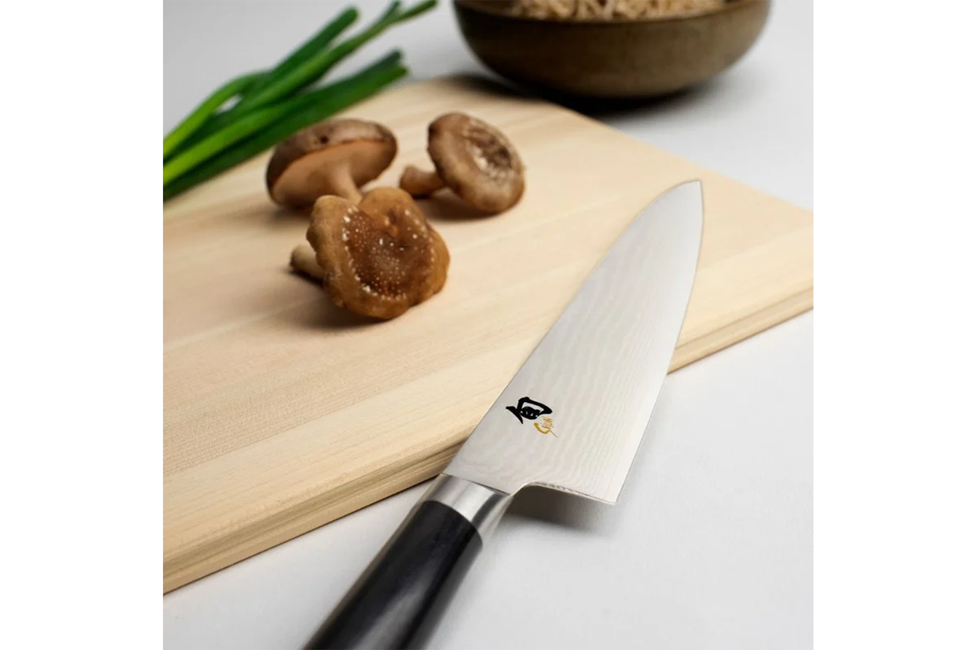 A chef's knife on a cutting board 