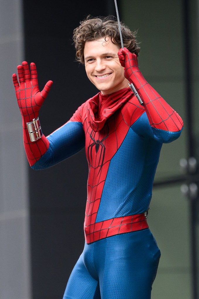 Tom Holland Stopping to Wave to Fans While Filming a Scene