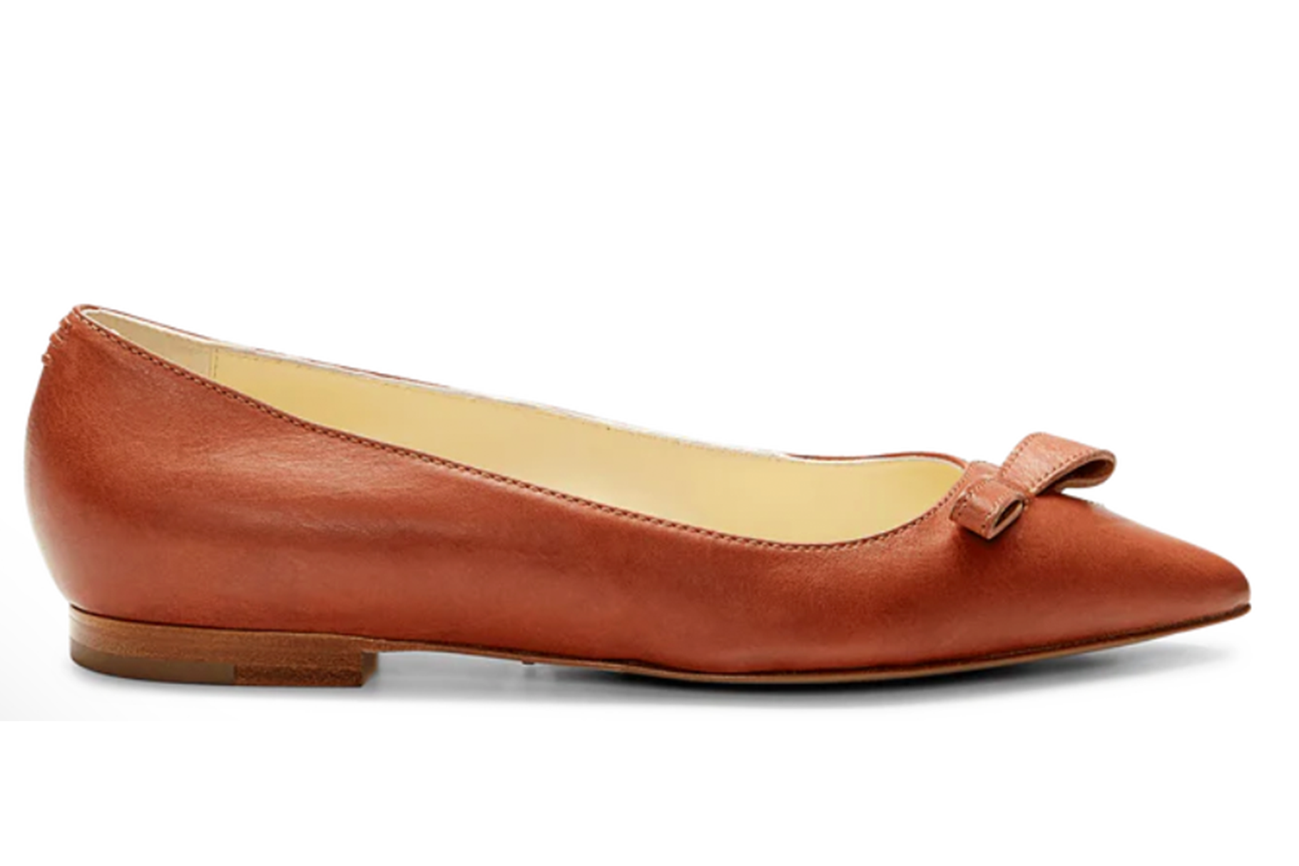 A single brown leather flat shoe with a bow.