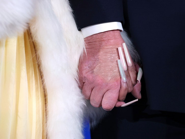 Nicki Minaj and U.S. President Donald Trump hold hands on stage getty