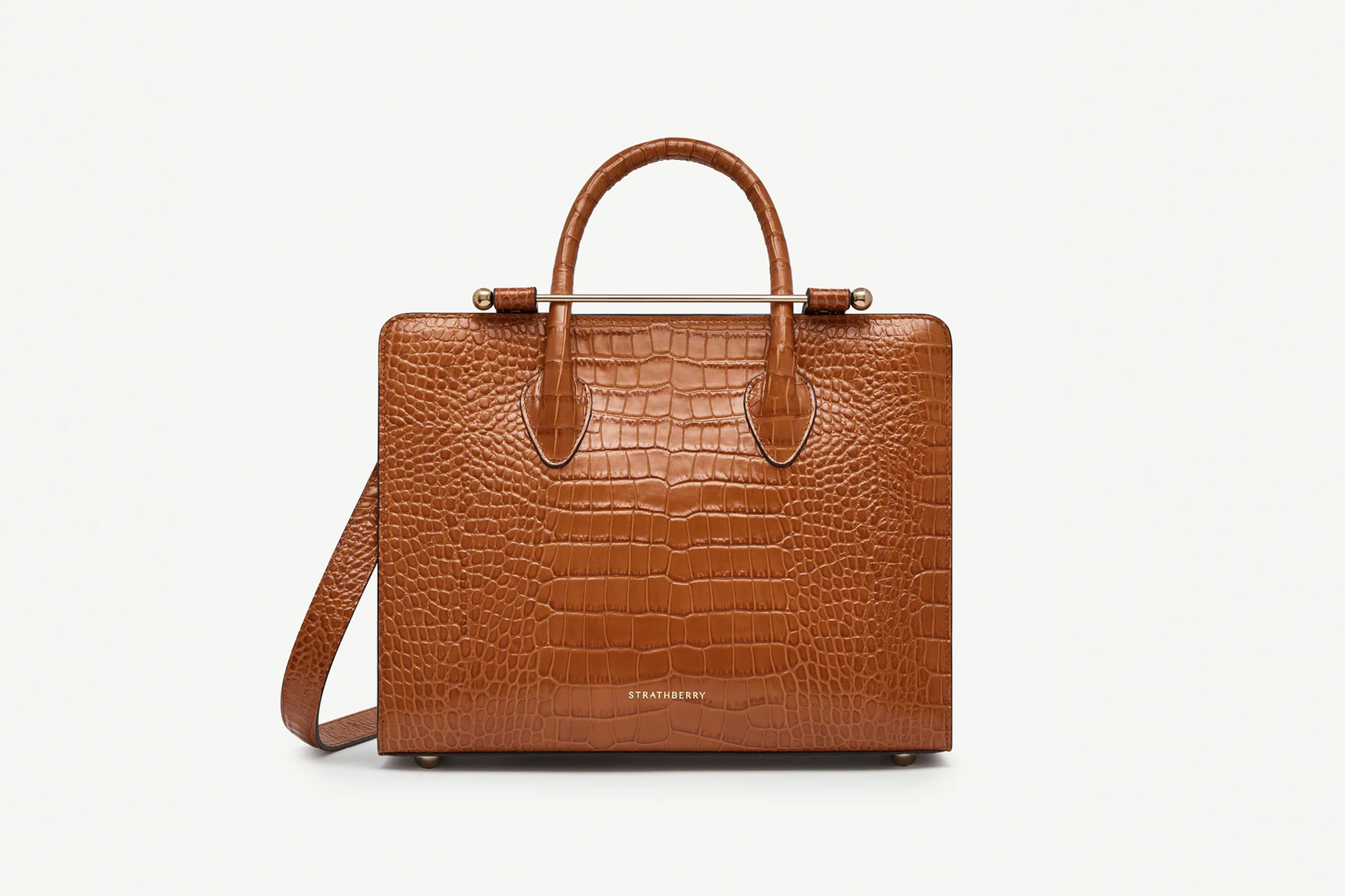 A Strathberry tote bag in brown crocodile-embossed leather with a gold bar closure and handle.
