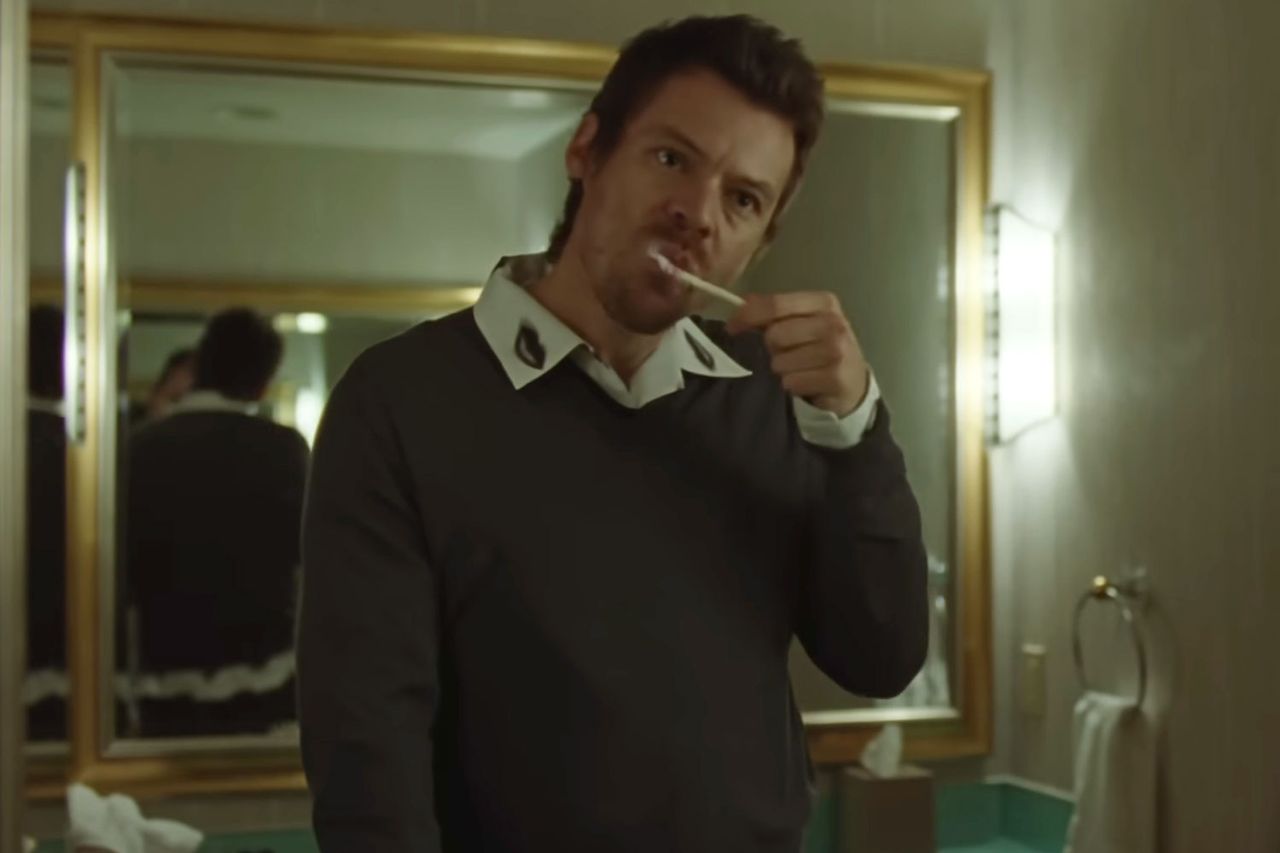 Harry Styles in a scene brushing his teeth from the music video for his song Aperture