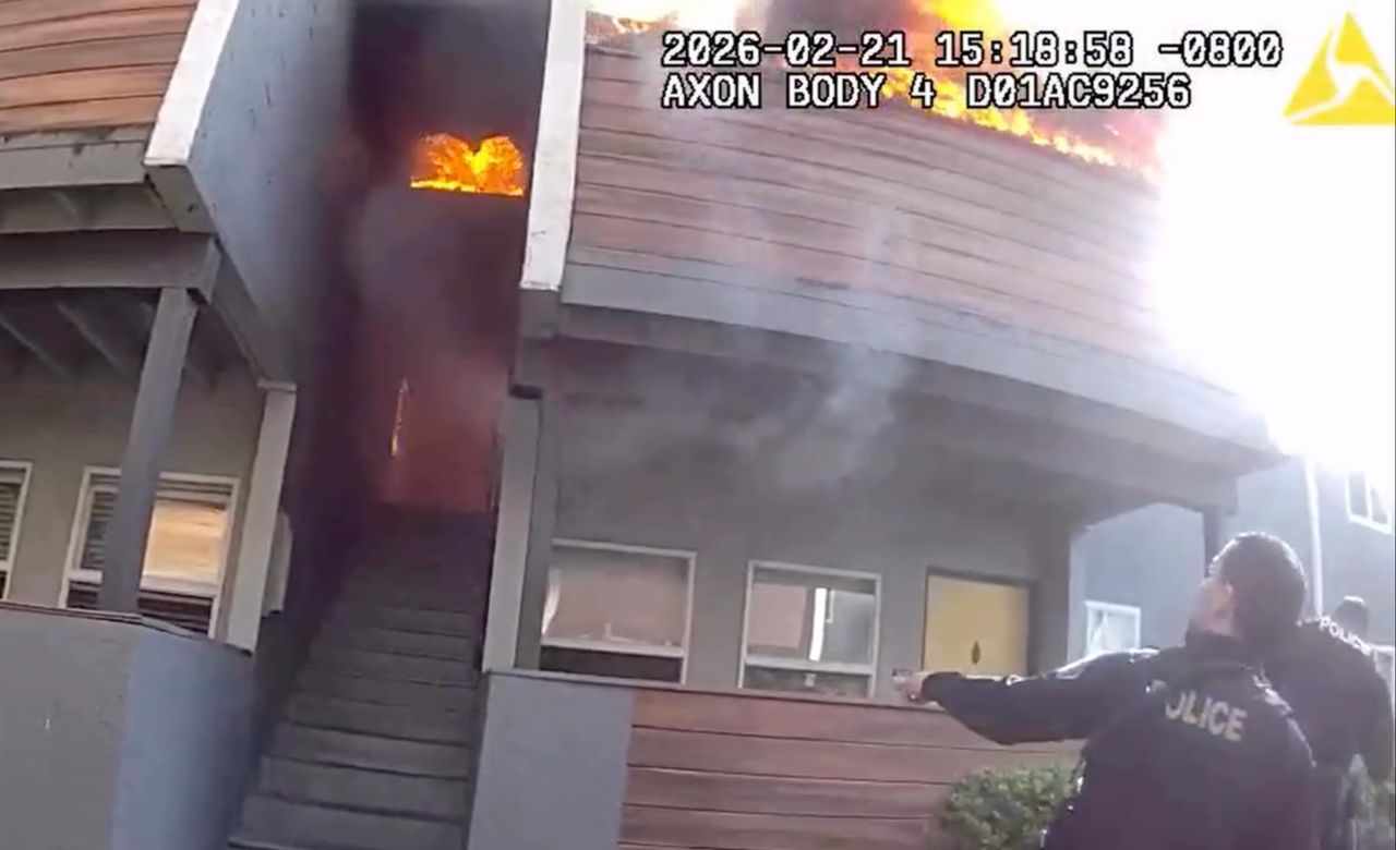 Officer catches dog off balcony during house fire on Feb. 21, 2026 in Milpitas, Calif.Credit: Milpitas Police Department/Instagram