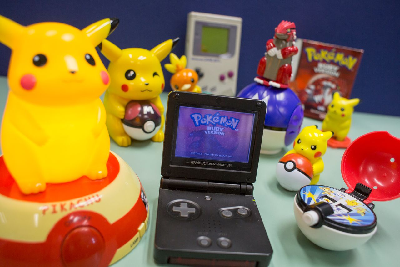 This image show Pokemon's video games, figure and toys. Pokémon Ruby on Game Boy SP with an original Game Boy in the backgroundCredit: May Tse/South China Morning Post/Getty