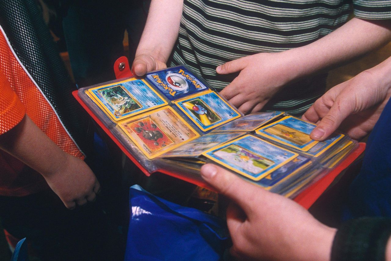POKEMON TRADING CARDS People look at a binder of Pokémon cardsCredit: Ray Tang/Shutterstock