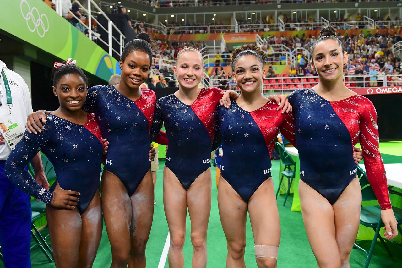 Simone Biles, Gabby Douglas, Madison Kocian, Laurie Hernandez and Aly Raisman pose for a photo at the 2016 Rio Olympics. Emmanuel DUNAND / AFP via Getty