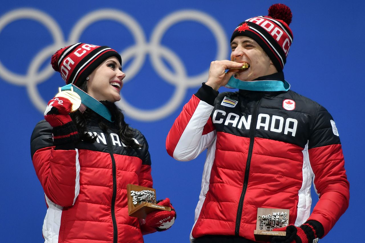 Tessa Virtue and Scott Moir with their medals at the 2018 Olympics. FABRICE COFFRINI/AFP/Getty