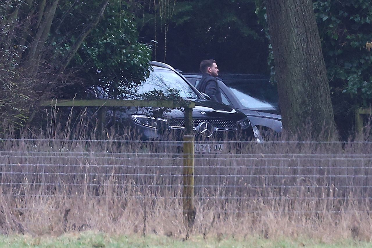 A man steps out of an unmarked car at the home of Andrew Mountbatten-Windsor Police officers on the Sandringham estate in Norfolk on Feb. 19, 2026 Peter Nicholls/Getty