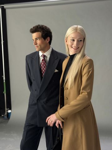Two individuals a man in a suit and a woman in a long coat posing in a studiolike setting Sarah Pidgeon and Paul Kelly as JFK Jr and Carolyn Besette KennedyCredit: Ryan Murphy Productions/Instagram