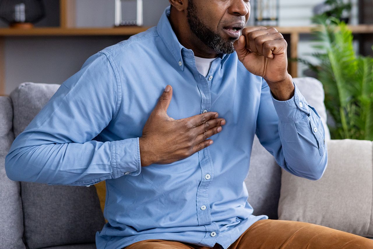 A man experiences a cough and chest pain Getty