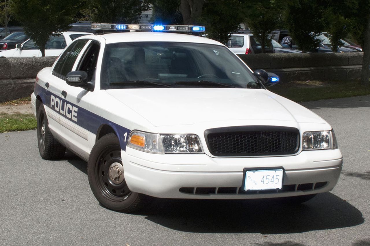 A police car with its emergency lights on parked on a street Police car (stock image) Getty