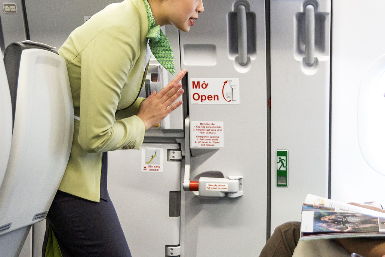 A flight attendant gives flight safety instructions to passengers in the economy class cabin A flight attendant speaks to a passenger.Credit: Maika Elan/Bloomberg via Getty