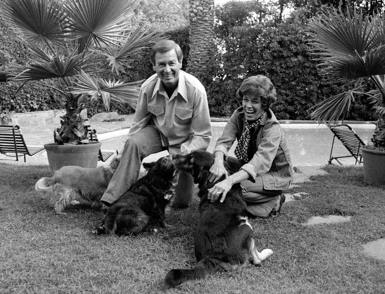 Bob and Dorothy Jo Barker play with their dogs in their backyard, 1977Credit: CBS Photo Archive/Getty