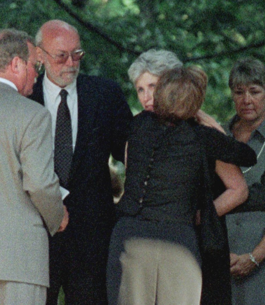 GREENWICH, : Anne Freeman (2nd R), mother of Lauren Bessette, receives a a hug beside her husband, Richard Freeman (2nd L), shortly before a memorial service for Lauren Bessette 24 July 1999 at Christ Church in Greenwich, Connecticut. Lauren Bessette was killed in a plane crash 16 July 1999 with her sister, Carolyn Bessette Kennedy and brother-in-law John F. Kennedy, Jr. AFP PHOTO/Stan HONDA (Photo credit should read STAN HONDA/AFP via Getty Images)
