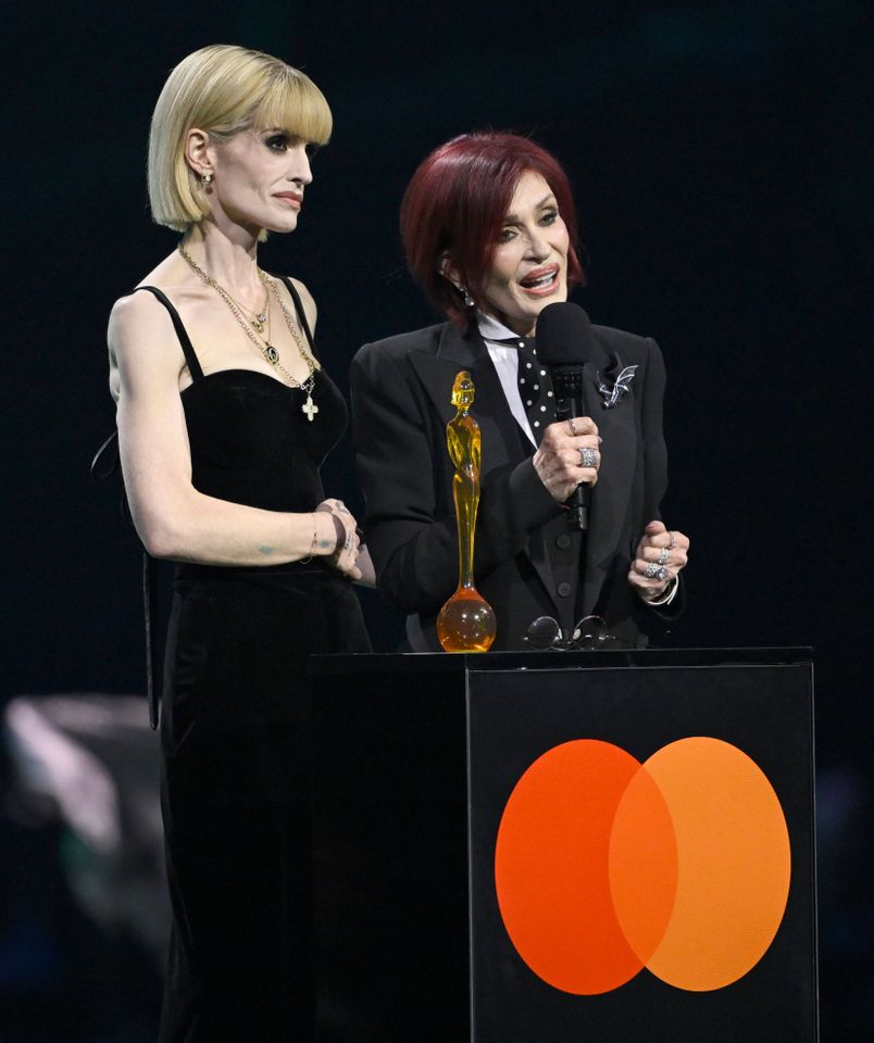 Kelly Osbourne and Sharon Osbourne accept the 'Lifetime Achievement' Award on behalf of the late Ozzy Osbourne on stage during The BRIT Awards 2026 Kelly and Sharon Osbourne onstage at the 2026 BRIT Awards in Manchester, England, on Feb. 28, 2026Credit: Gareth Cattermole/Getty