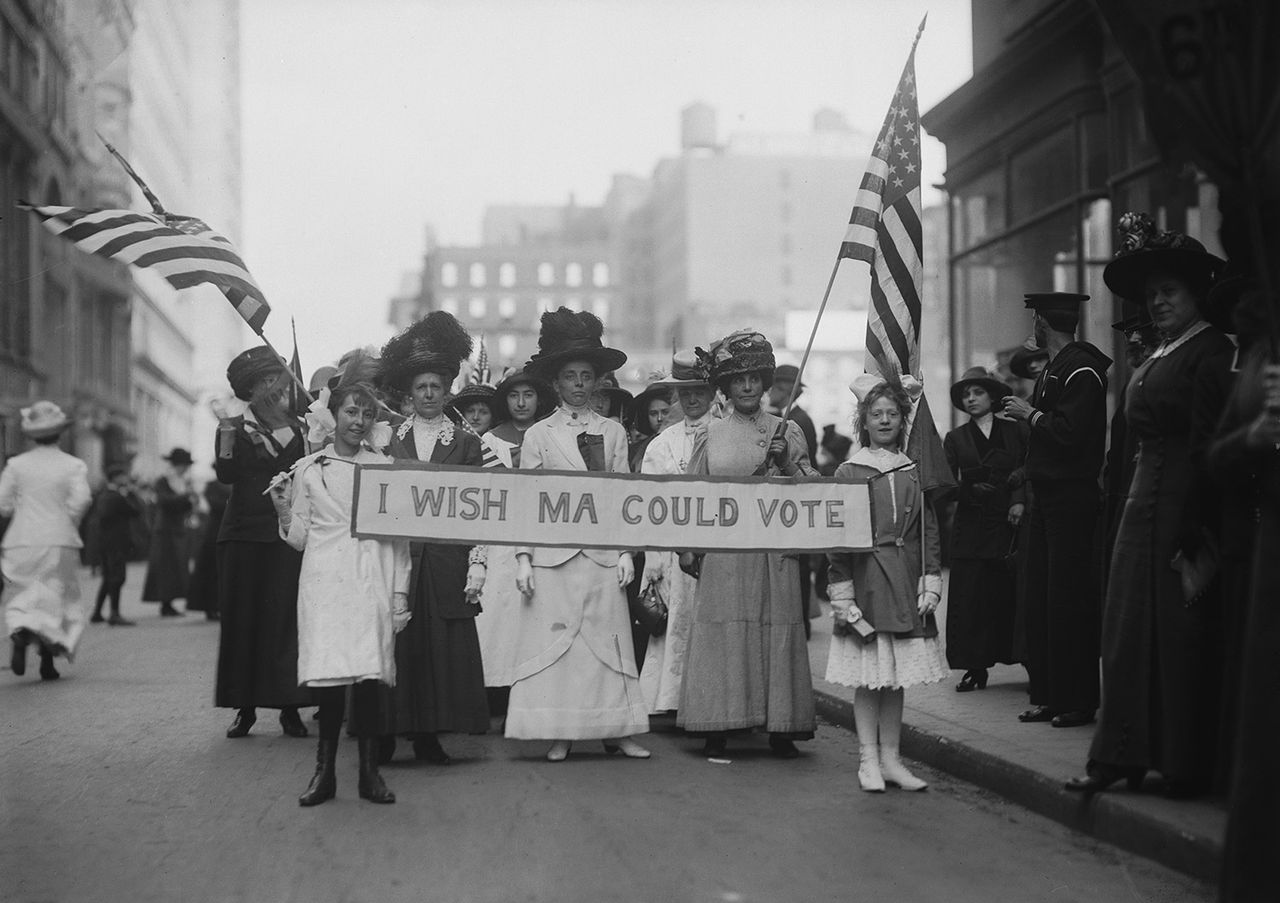 A group of women's suffrage activists march in a parade carrying a banner reading 'I Wish Ma Could Vote,' circa 1913Credit: Getty Images