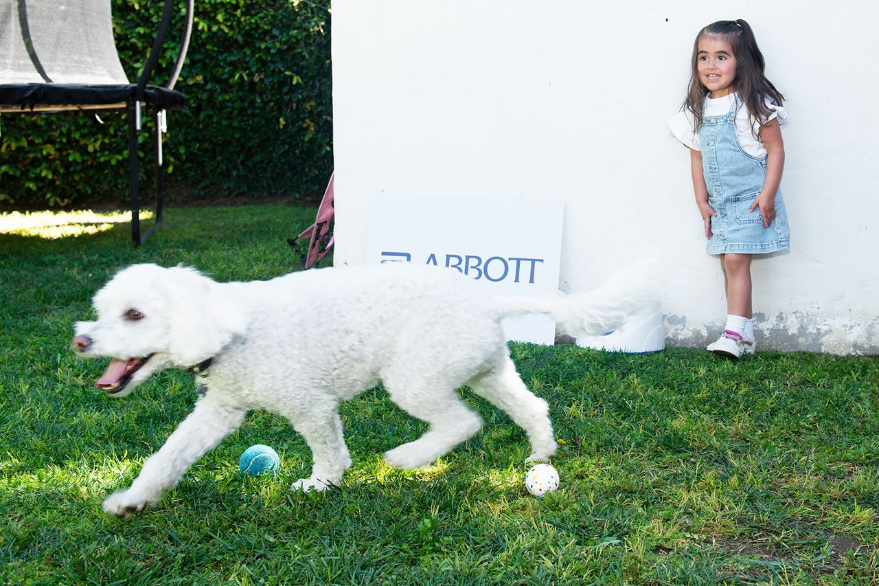 Child and dog playing together at Abbott event in Los AngelesCredit: Abbott