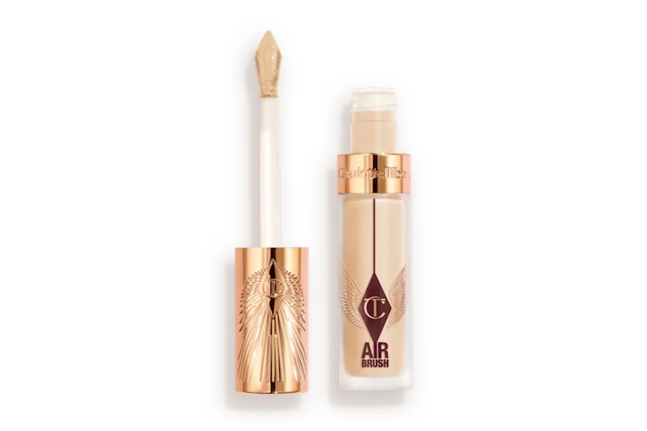 A tube of concealer and its applicator wand with a decorative design on the lid Credit: Charlotte Tilbury