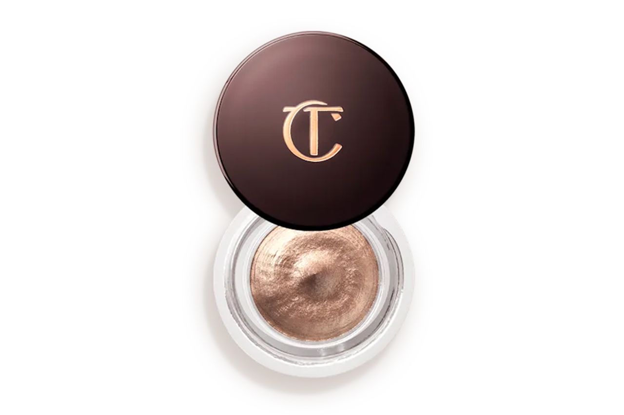 A cosmetic product a makeup container with a logo on the lid and a light shimmering substance visible inside Credit: Charlotte Tilbury