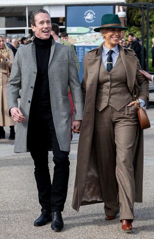 Hannah Waddingham arrives at Cheltenham Festival hand-in-hand with Nick Beresford-Cleary, a consultant spine surgeon, on Gold Cup Day. The couple enjoys the prestigious jump racing finale together at the Gloucestershire racecourse. Nick Beresford-Cleary and Hannah Waddingham.Credit: James Watkins / BACKGRID