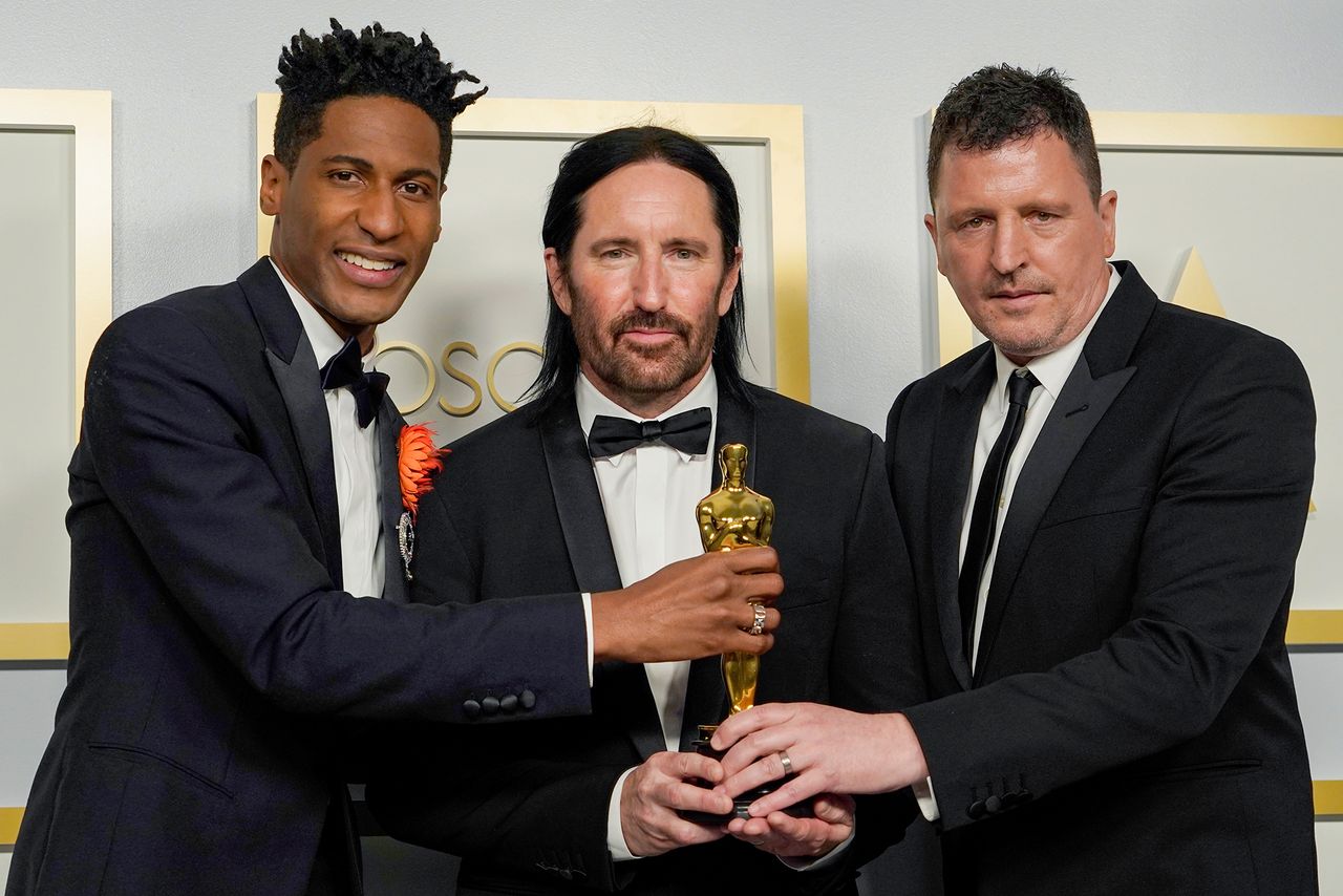 From left: Jon Batiste, along with Trent Reznor and Atticus Ross of Nine Inch Nails, hold their Oscar for Best Original Score during the 93rd Academy Awards at Union Station on April 25, 2021Credit: Chris Pizzello-Pool/Getty