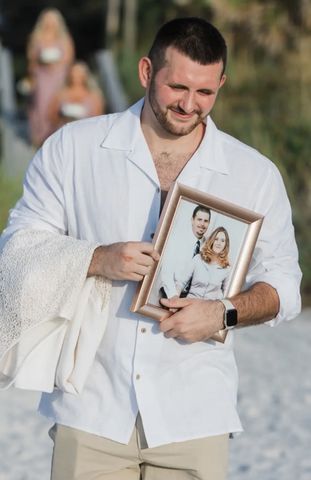 Katy Garrett's brother Kyle carrying photo of late-parentsCredit: Katy Garrett