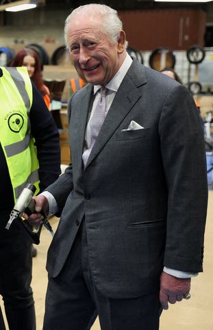 Britain's King Charles III uses a stapler to help restore a chair, refurbished using materials from the Royal Opera House, during the launch of 'Circularity in Practice' at The Renew Hub King CharlesCredit: Phil Noble / POOL / AFP via Getty