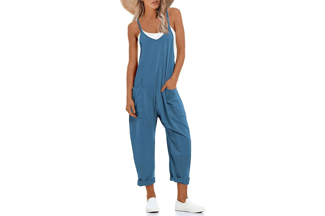 A model wearing a casual blue jumpsuit and white sneakers hands in pockets Credit: Amazon