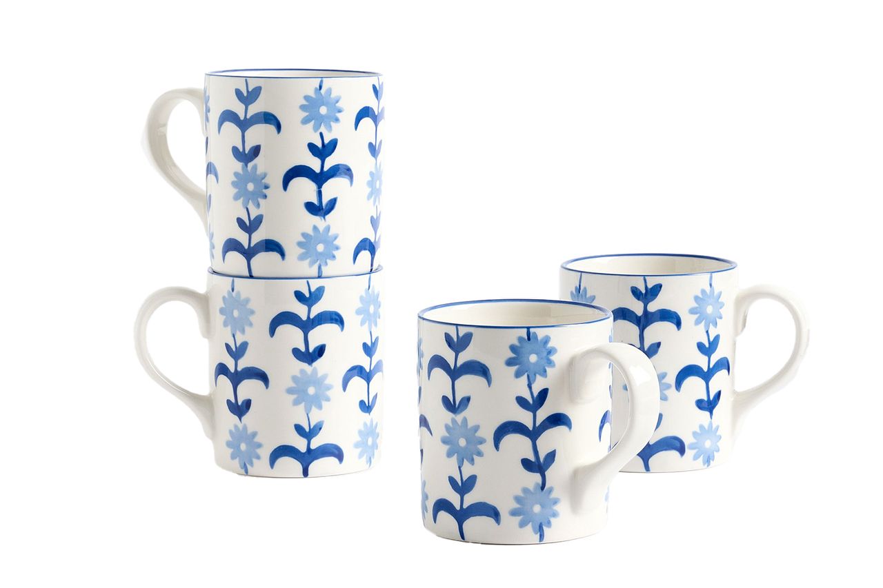 A set of four mugs with a blue floral pattern in an arrangement with one stacked pair Credit: Pottery Barn