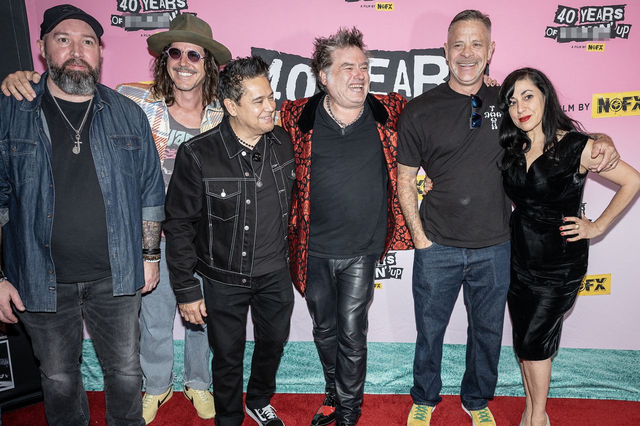 Fat Mike and Cisco Adler attending an event with a group in front of a backdrop featuring NOFX branding James Buddy Day, Cisco Adler, El Jefe, Fat Mike, Smelly, and Karina DenikeCredit: Alan Snodgrass