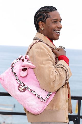 A$AP Rocky sports a pink purse accessorized with Chanel baby shoesCredit: Stephane Cardinale/Corbis/Getty