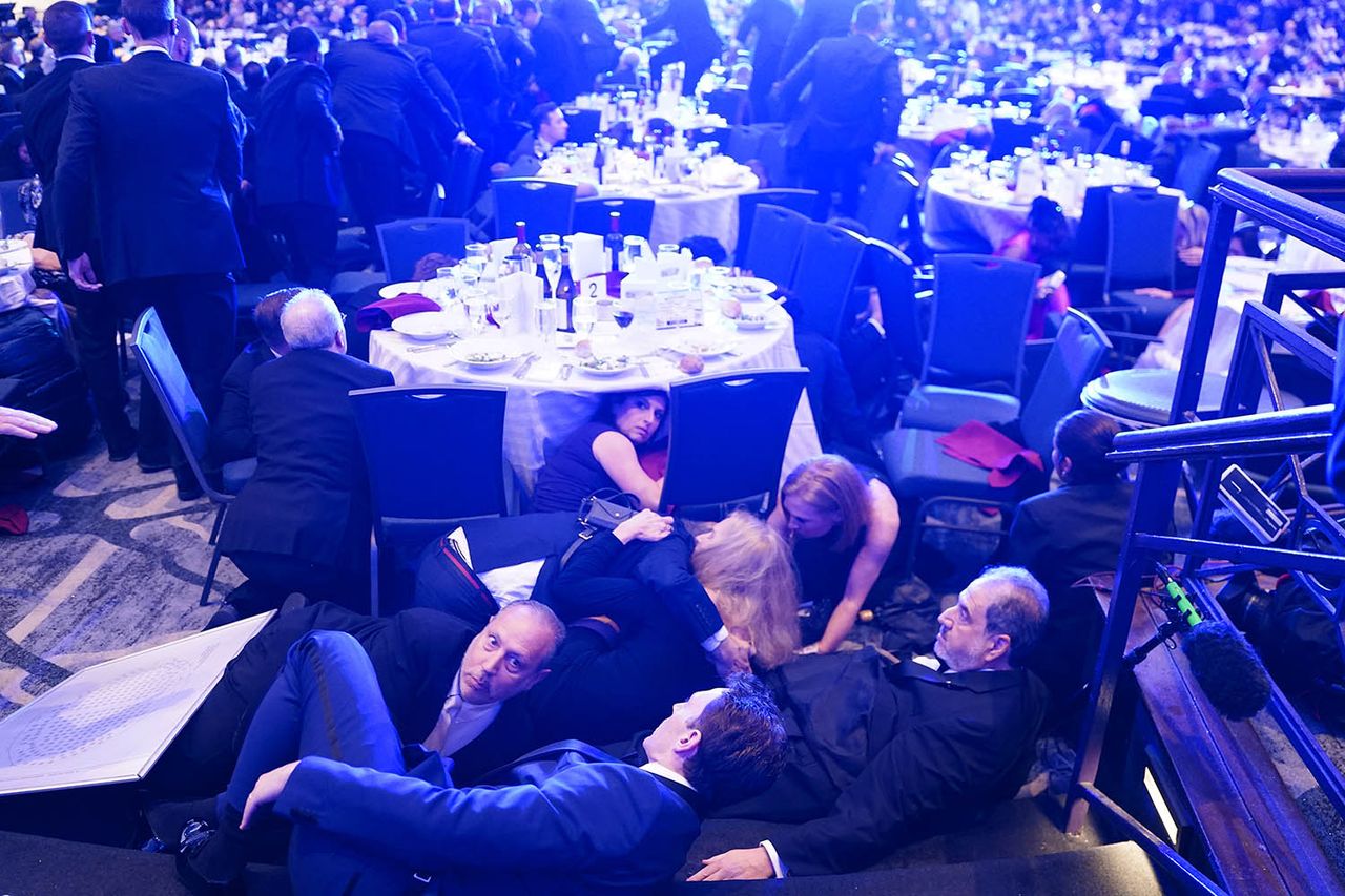 Attendees duck under tables at the White House Correspondents' Dinner on April 25, 2026Credit: Nathan Howard/Getty