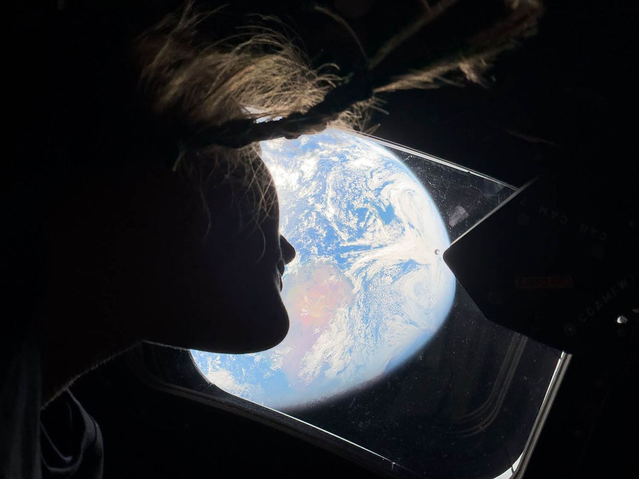 In this handout image provided by NASA, NASA astronaut and Artemis II mission specialist Christina Koch peers out of one of the Orion spacecraft's main cabin windows, looking back at Earth, as the crew travels towards the Moon on April 4, 2026. Christina Koch on the Orion spacecraftCredit: NASA via Getty