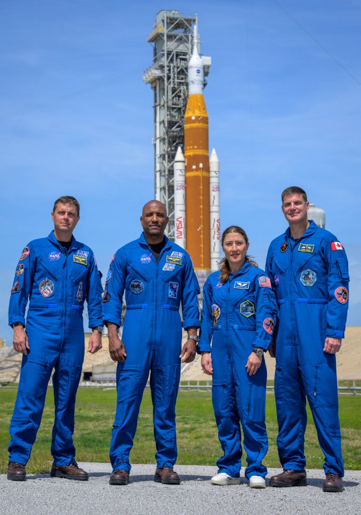 NASA astronauts Reid Wiseman, Artemis II commander, left, Victor Glover, Artemis II pilot, Christina Koch, Artemis II mission specialist, and CSA (Canadian Space Agency) astronaut Jeremy Hansen, Artemis II mission specialist, right, stop for a group photograph as they visit NASA’s Artemis II SLS (Space Launch System) rocket and Orion spacecraft, Monday, March 30, 2026, at Launch Complex 39B of NASA’s Kennedy Space Center in Florida. Photo Credit: (NASA/Bill Ingalls)