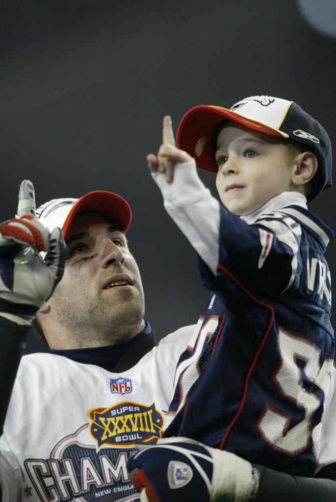 UNITED STATES - FEBRUARY 01: Football: Super Bowl XXXVIII, Closeup of New England Patriots Mike Vrabel and son Tyler victorious after game vs Carolina Panthers, Houston, TX 2/1/2004 (Photo by John Biever/Sports Illustrated via Getty Images) (SetNumber: X70032 TK4 R7 F20)