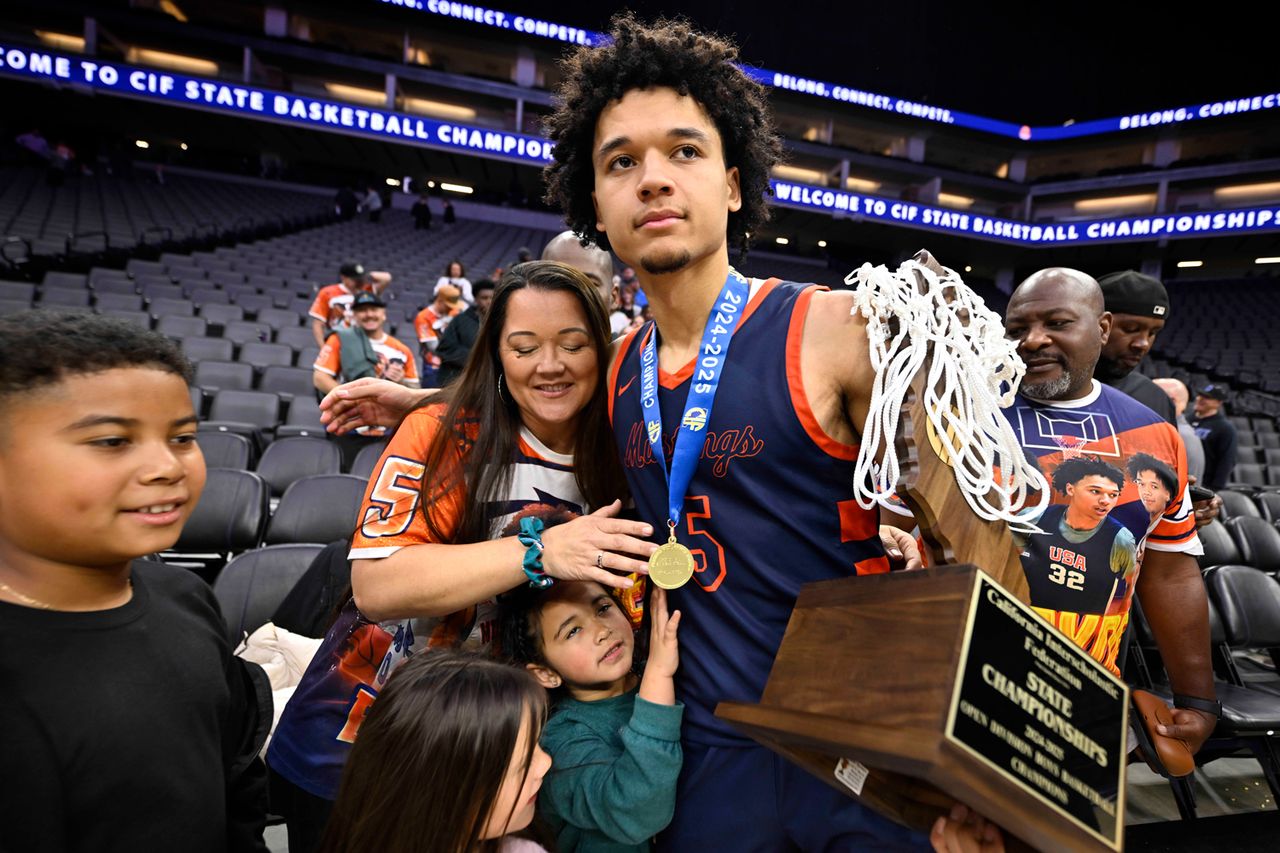Brayden Burries #5 of Roosevelt Mustangs holding the trophy hugs his mother Hannah after the CIF State Open Division championship basketball game on March 15, 2025 in Sacramento, California.Credit: Keith Birmingham/MediaNews Group/Pasadena Star-News via Getty