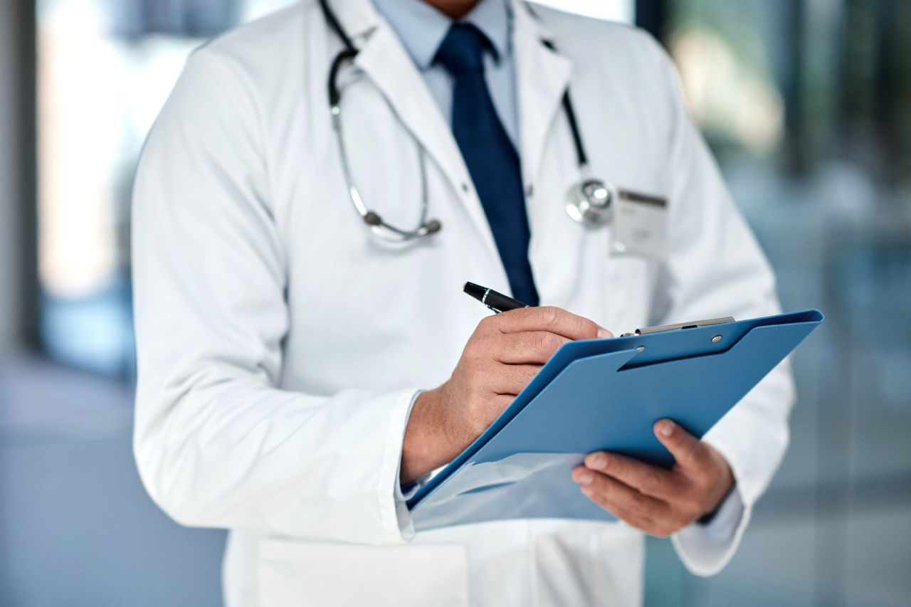 Cropped shot of an unrecognisable doctor writing notes in a folder in a modern hospital Stock image of a doctor writing notesCredit: Getty