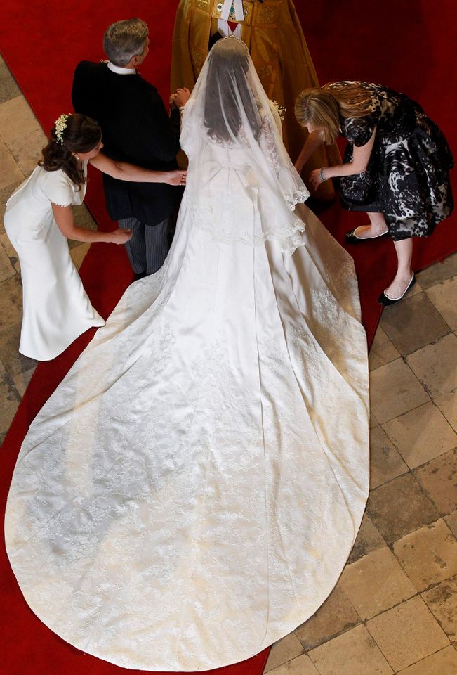Catherine Middleton has her dress adjusted by her sister and Maid of Honor Pippa Middleton as she arrives with her father Michael Middleton before her wedding at Westminster Abbey on April 29, 2011 in London, England.Credit: Suzanne Plunkett - WPA Pool/Getty