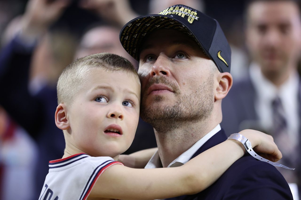 Luke Murray holds his son during the NCAA Men's Basketball Tournament National Championship game on April 03, 2023 in Houston, Texas. Luke Murray holds his son during the NCAA Men's Basketball Tournament National Championship game on April 03, 2023 in Houston, Texas.Credit: Gregory Shamus/Getty
