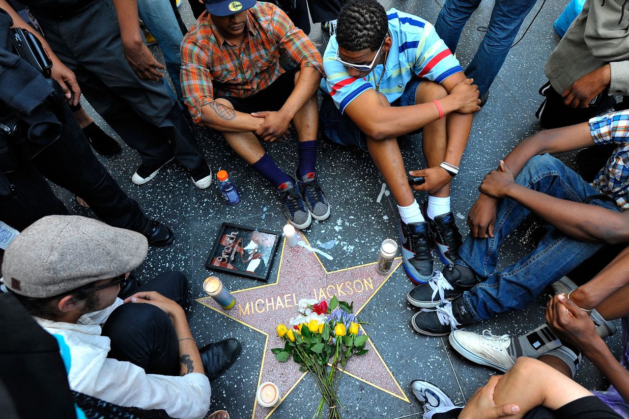 Fans of pop star Michael Jackson sit vigil at his star on the Hollywood Walk of Fame mourning his death on June 25, 2009 in Los Angeles, California.Credit: Charley Gallay/Getty
