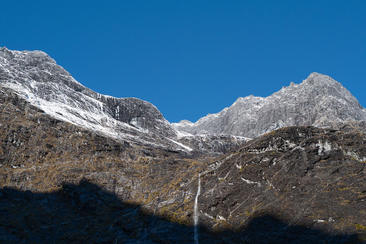Large rock face above the tunnel exit on the drive to Milford Sound Milford Sound in Fiordland National Park, New ZealandCredit: Getty